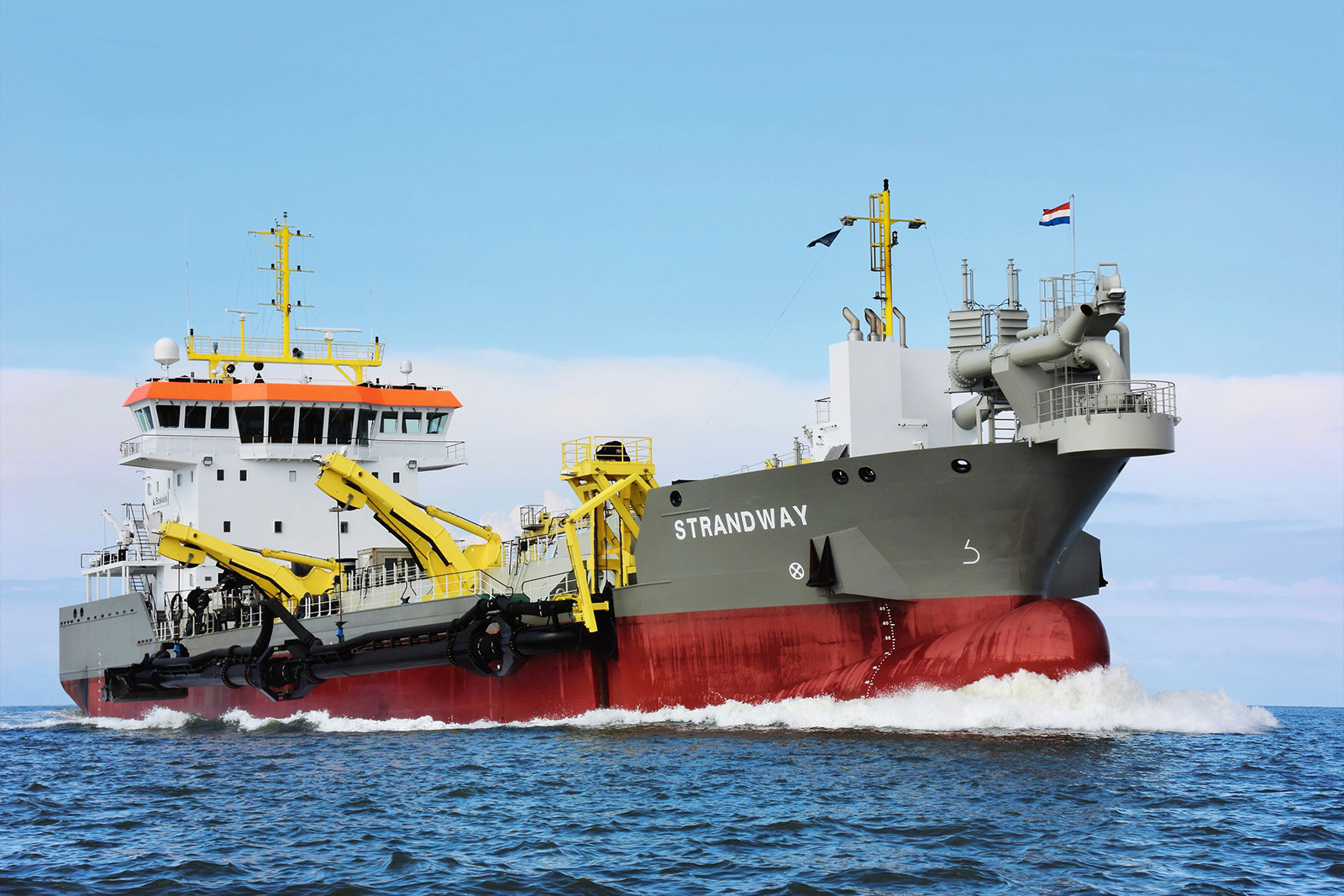 Trailing suction hopper dredger Strandway lowering its suction pipe to dredge sand